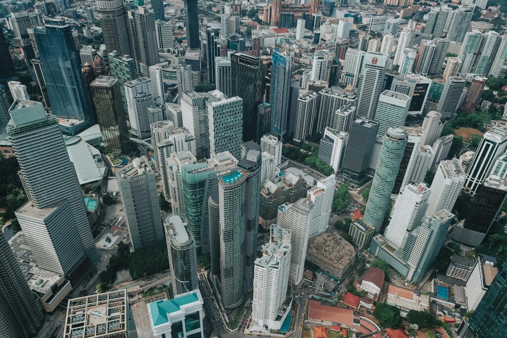 Aerial view of contemporary city district with tall glass skyscrapers of futuristic style in daylight