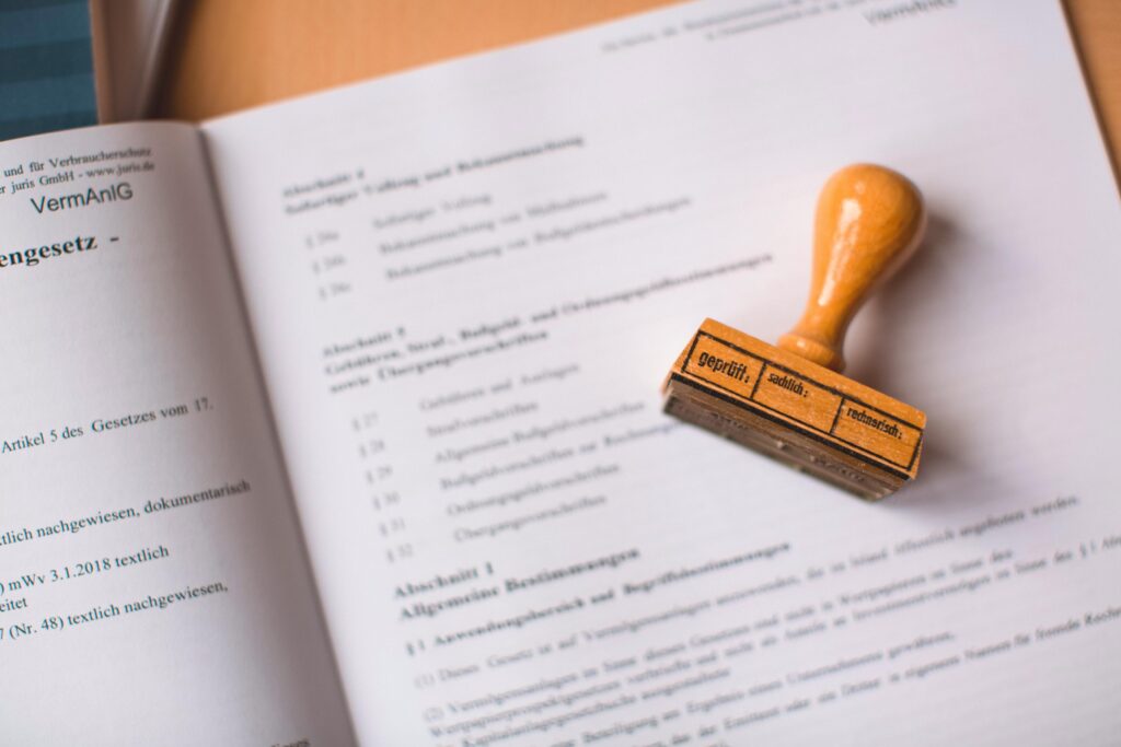 Close-up of a legal document with a wooden stamp placed on top, highlighting verification.